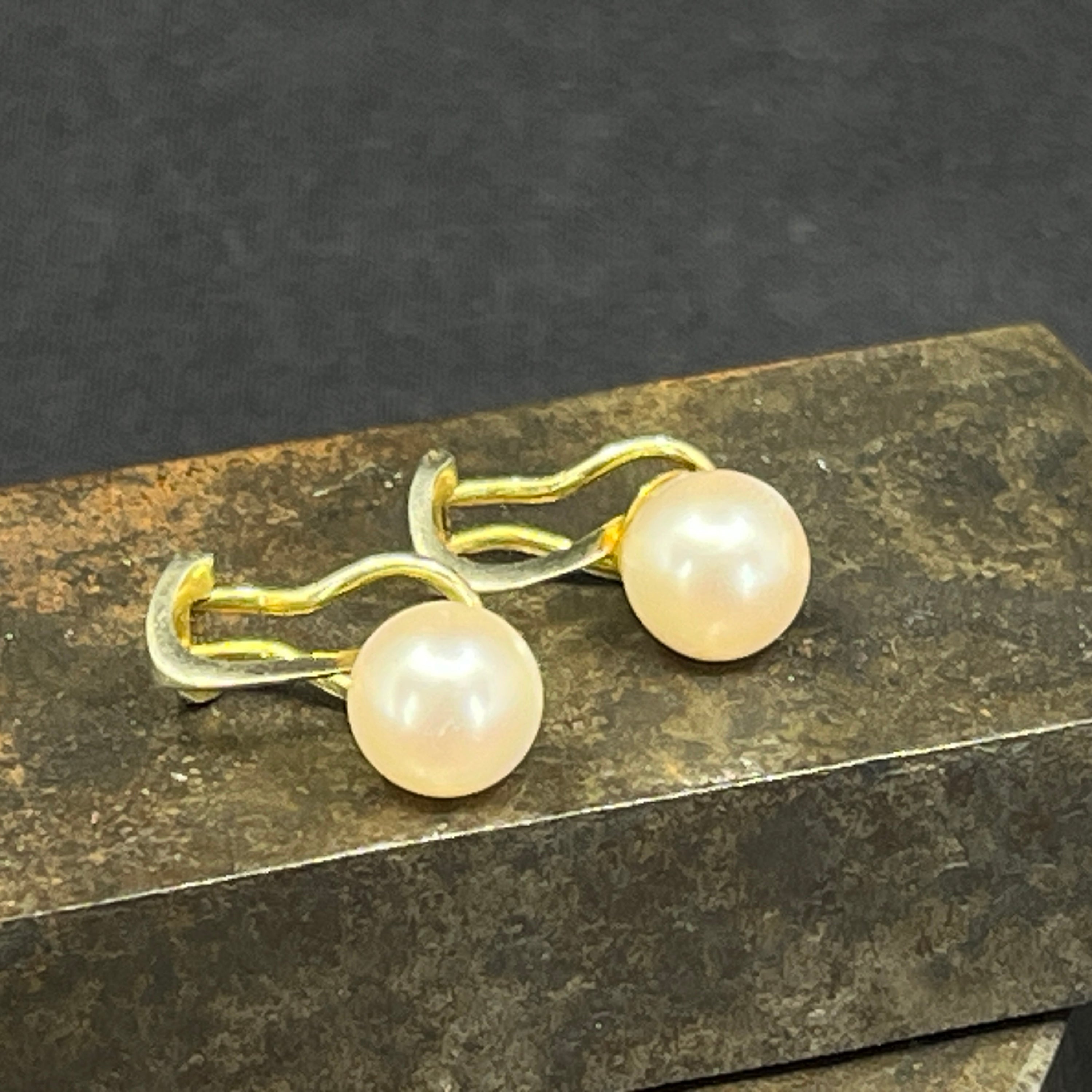 A pair of gold-plated silver clip-on earrings with pearls