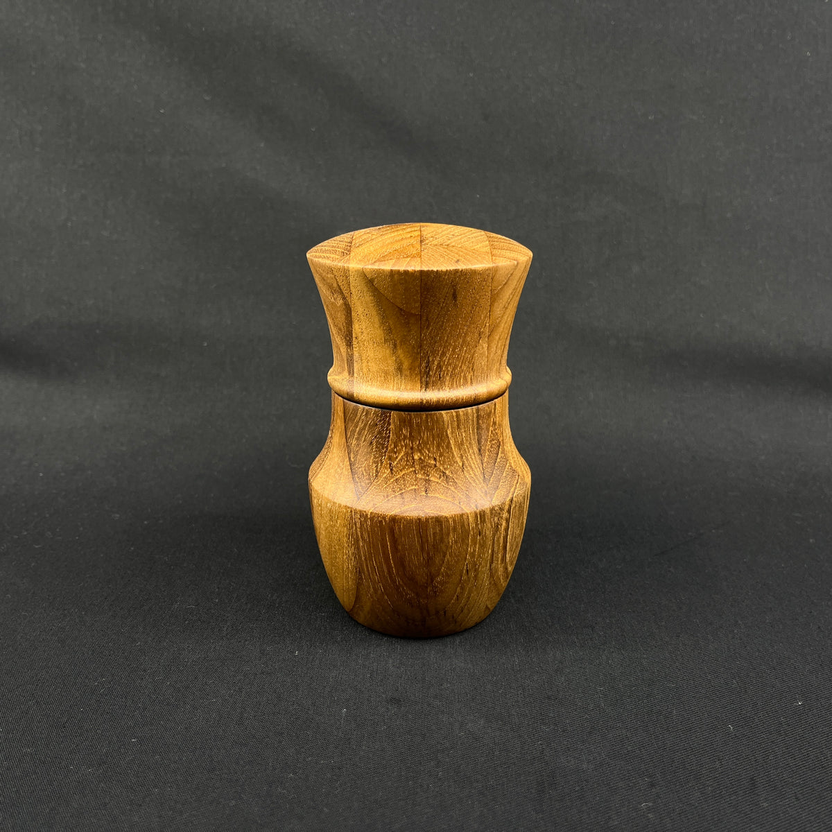Modern pepper mill in teak