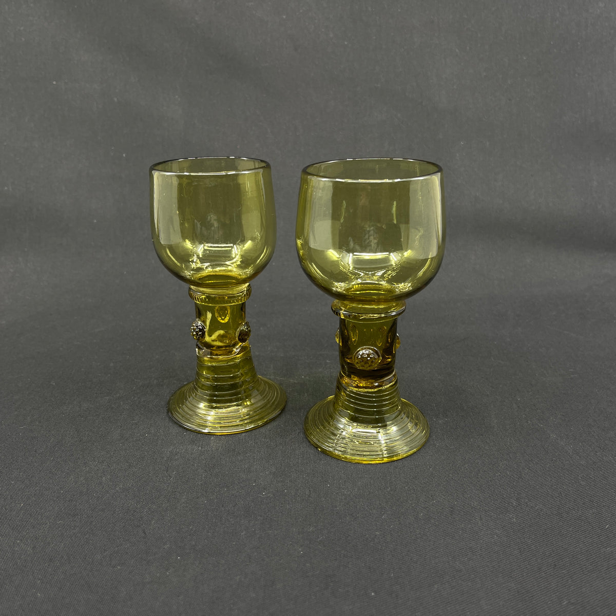 A pair of antique Röhmer glasses with hollow stems