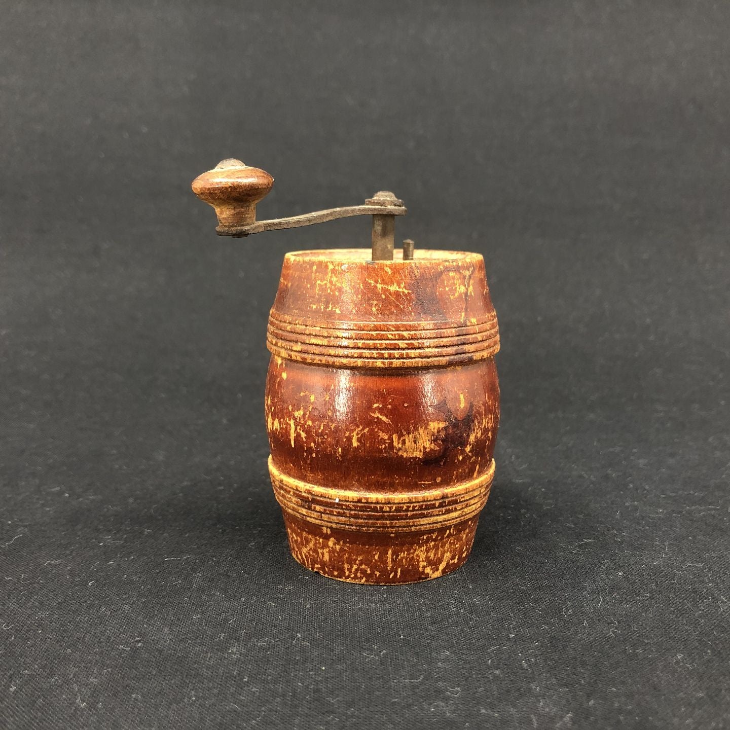 Older pepper grinder in red painted wood