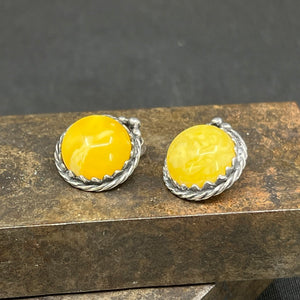 A pair of clip-on earrings with milky amber