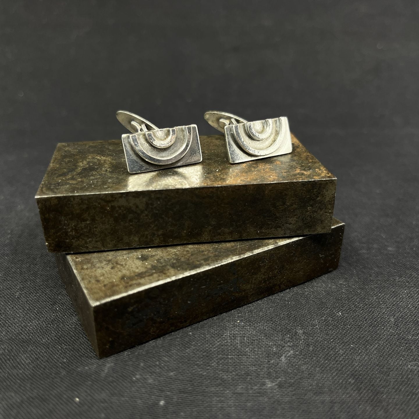 A pair of cufflinks with bows