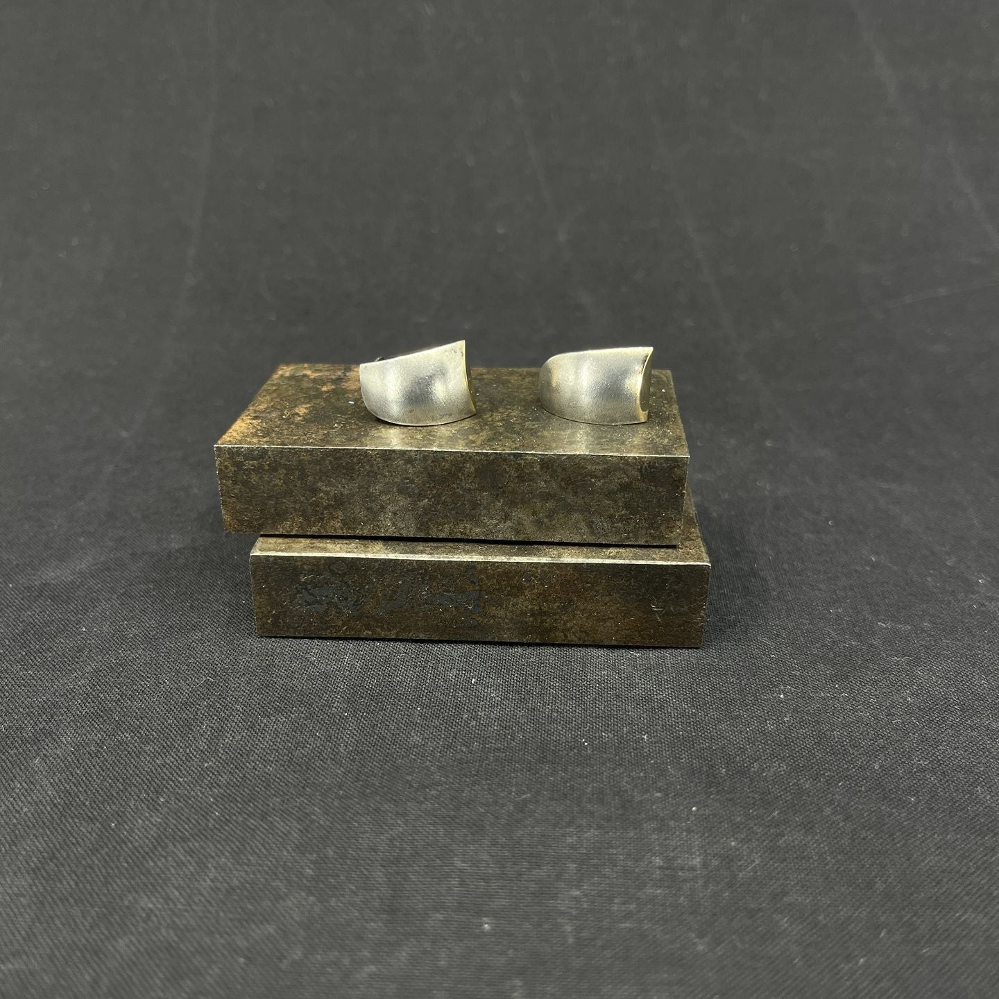 A pair of modern ear clips with gold