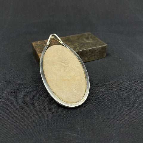 Pendant with petrified leaf