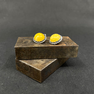 A pair of clip-on earrings with milky amber
