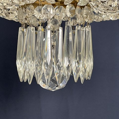 Fine dense chandelier with glass crown and garland