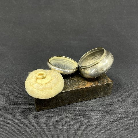 Small silver box with powder brush