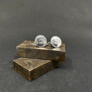 A pair of cufflinks with Ping