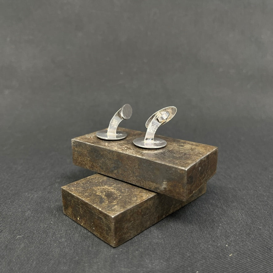 A pair of cufflinks with Ping