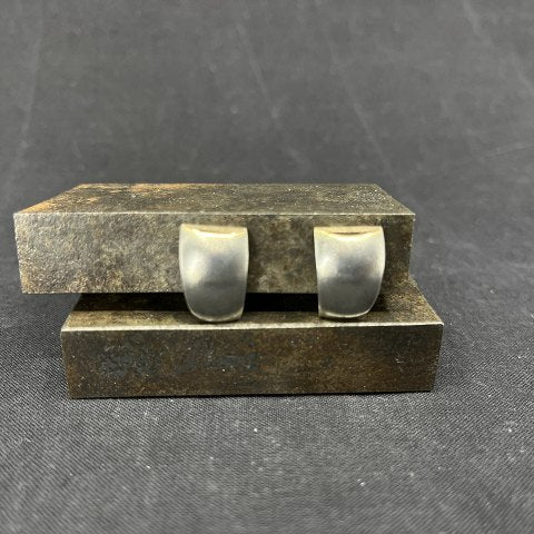 A pair of modern ear clips with gold