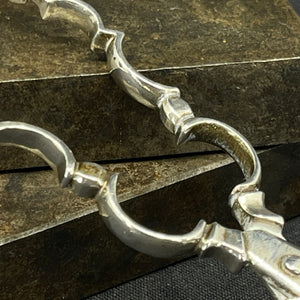 Baroque sugar tongs in silver