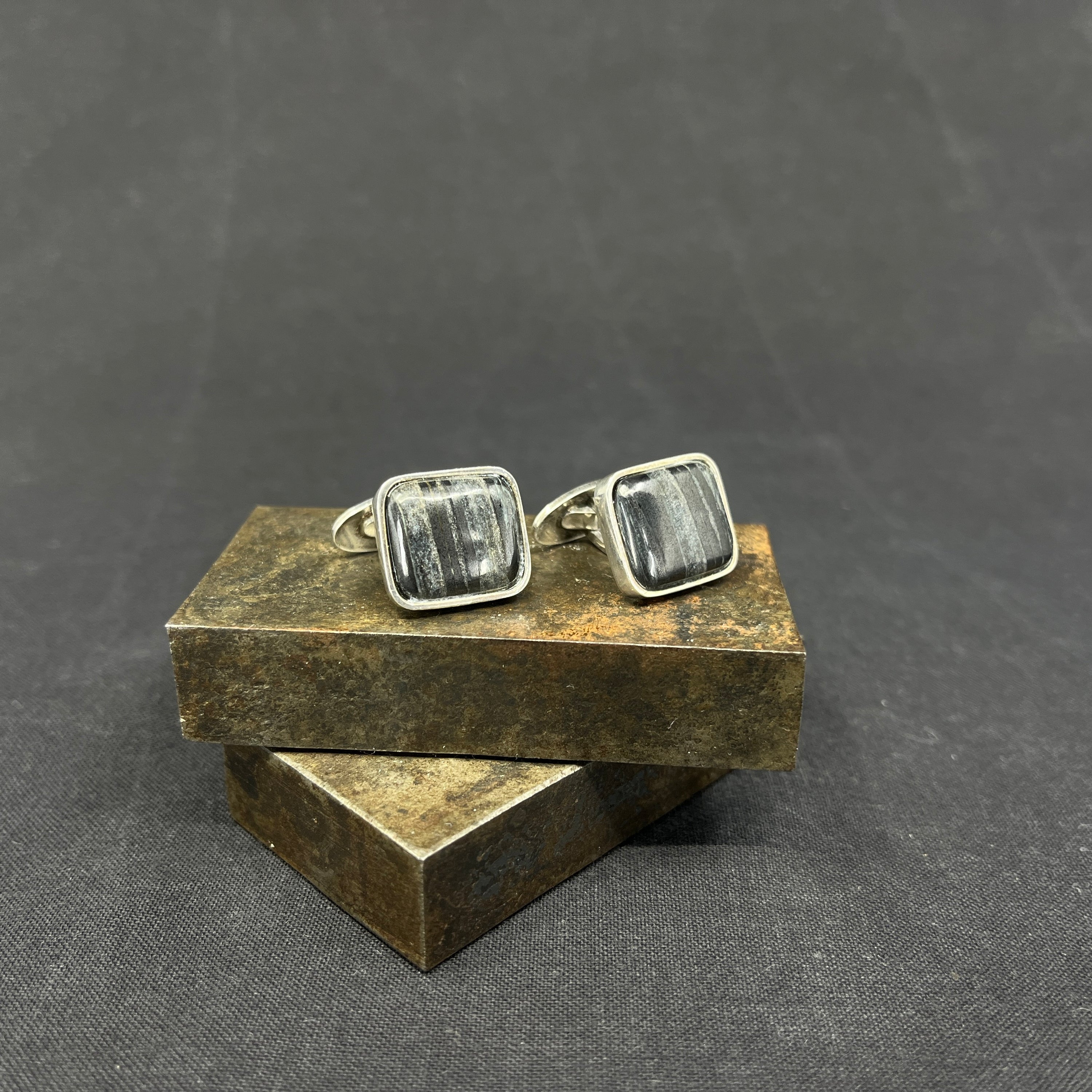 A pair of cufflinks with stones
