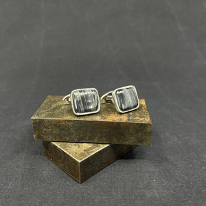 A pair of cufflinks with stones