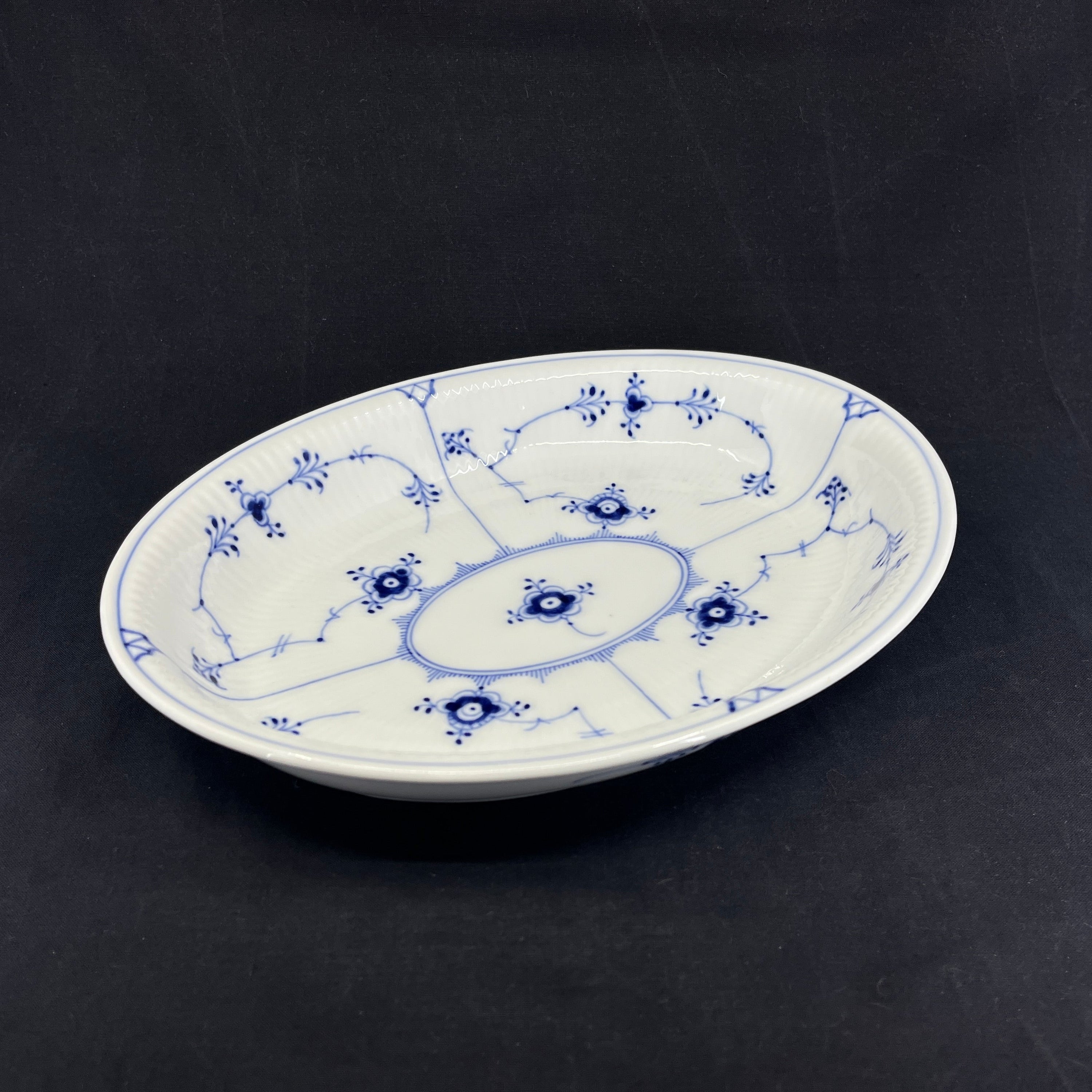 Fluted oval dish with high rim