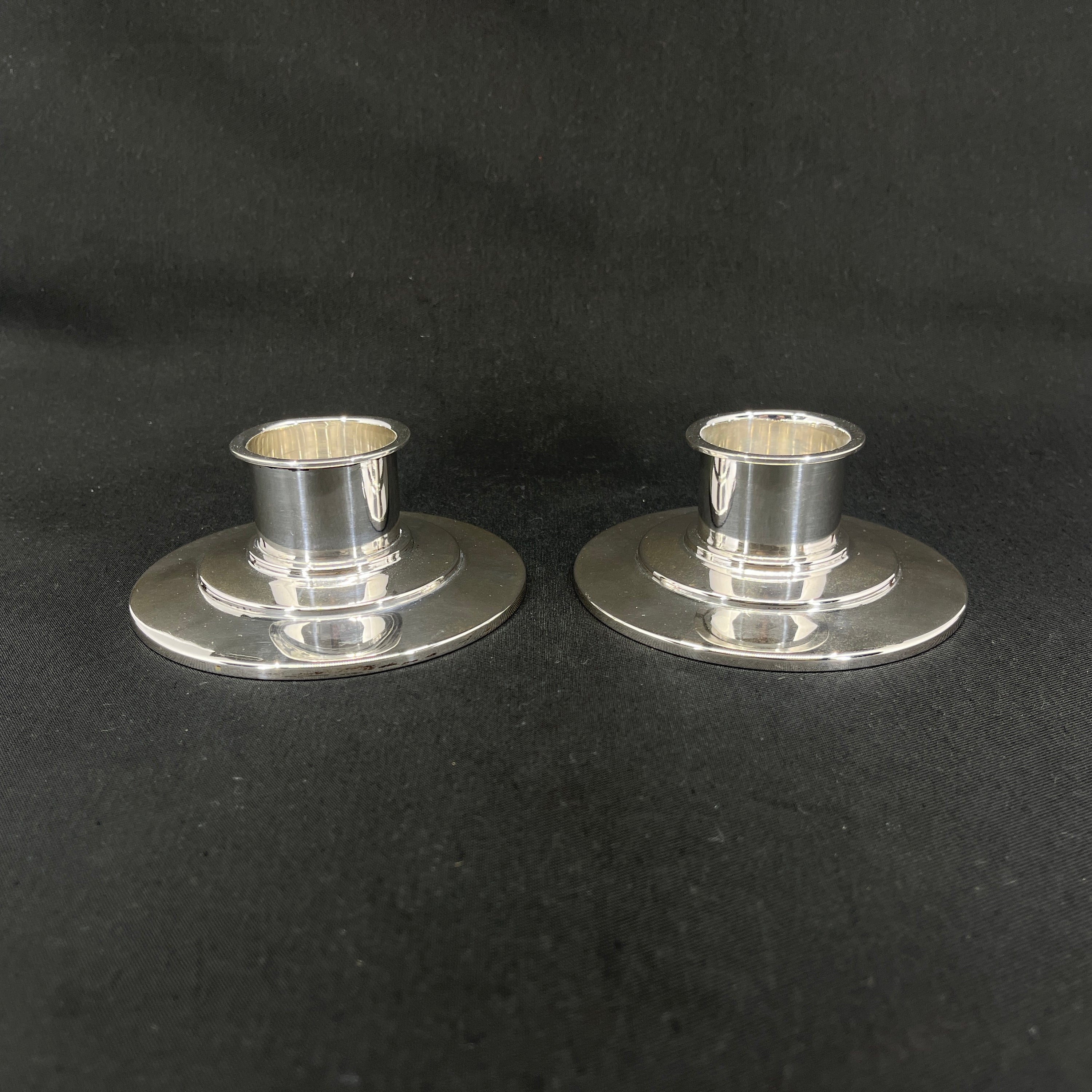 A pair of art deco silver candlesticks