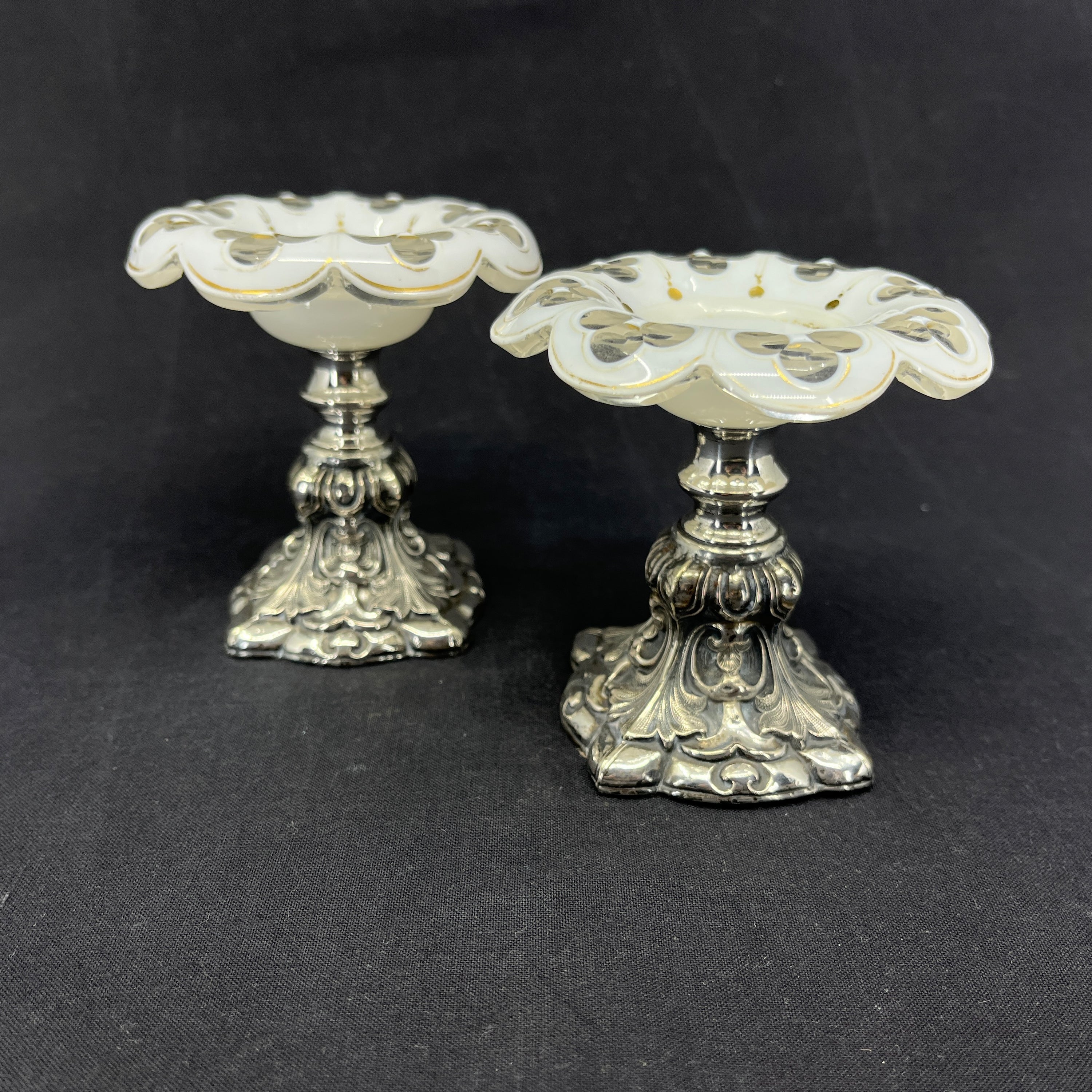 A pair of glass bowls with silver base