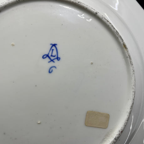 A pair of Sevres plates with scattered flowers