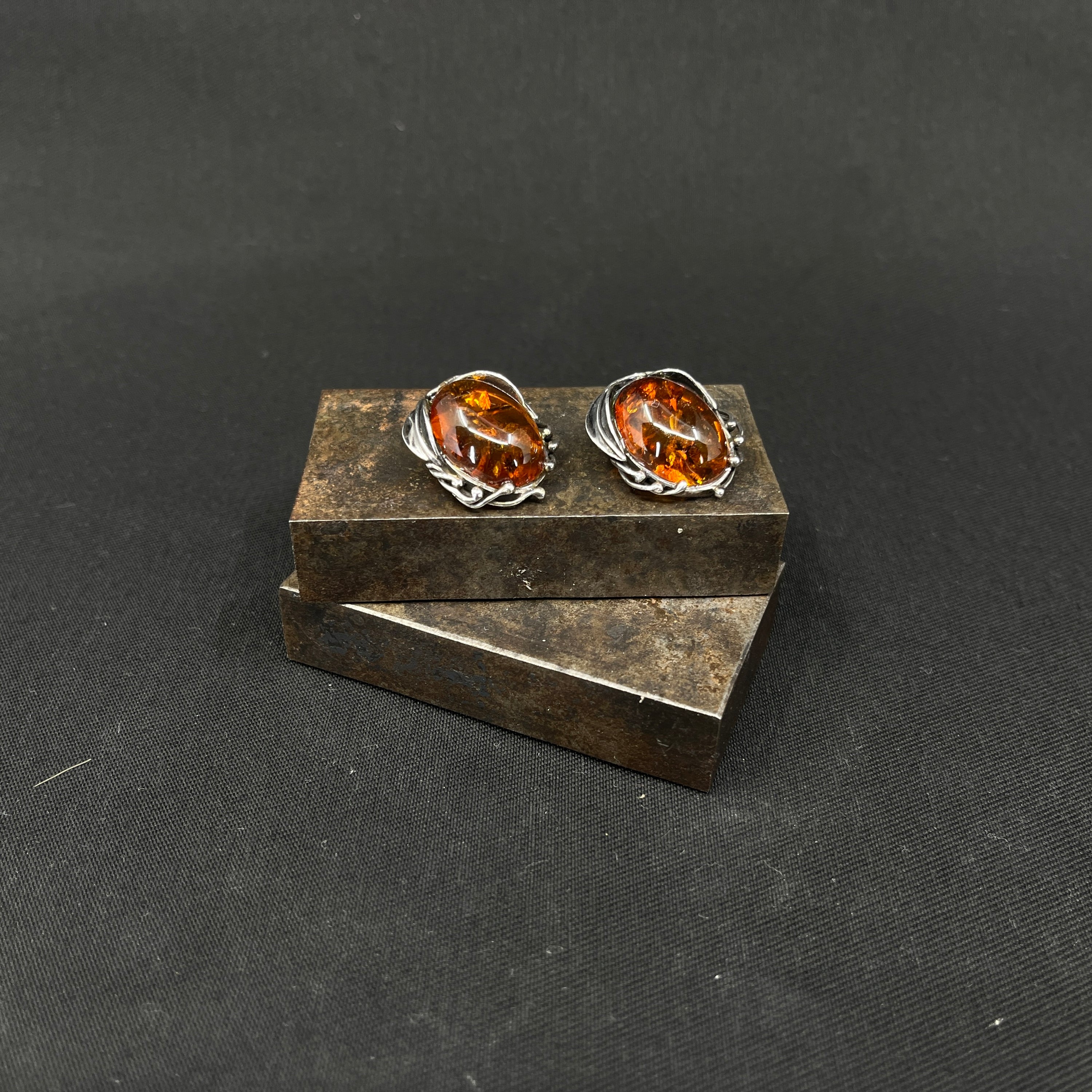 A pair of earrings with amber