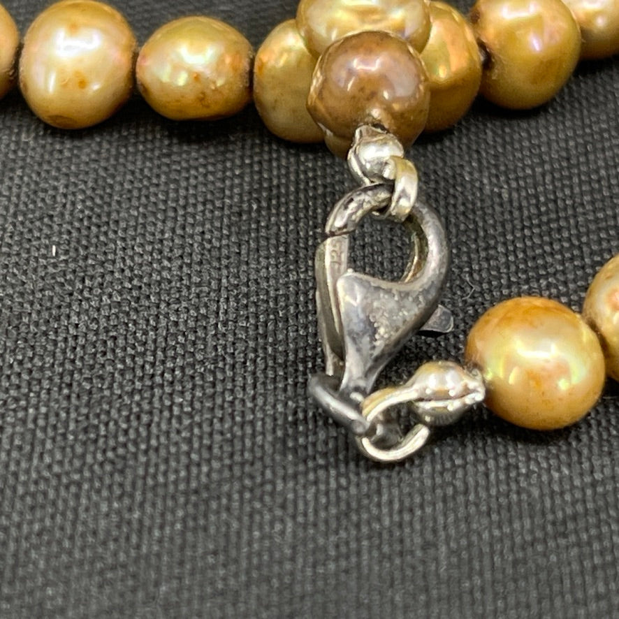 Gold-tone pearl necklace with a silver clasp
