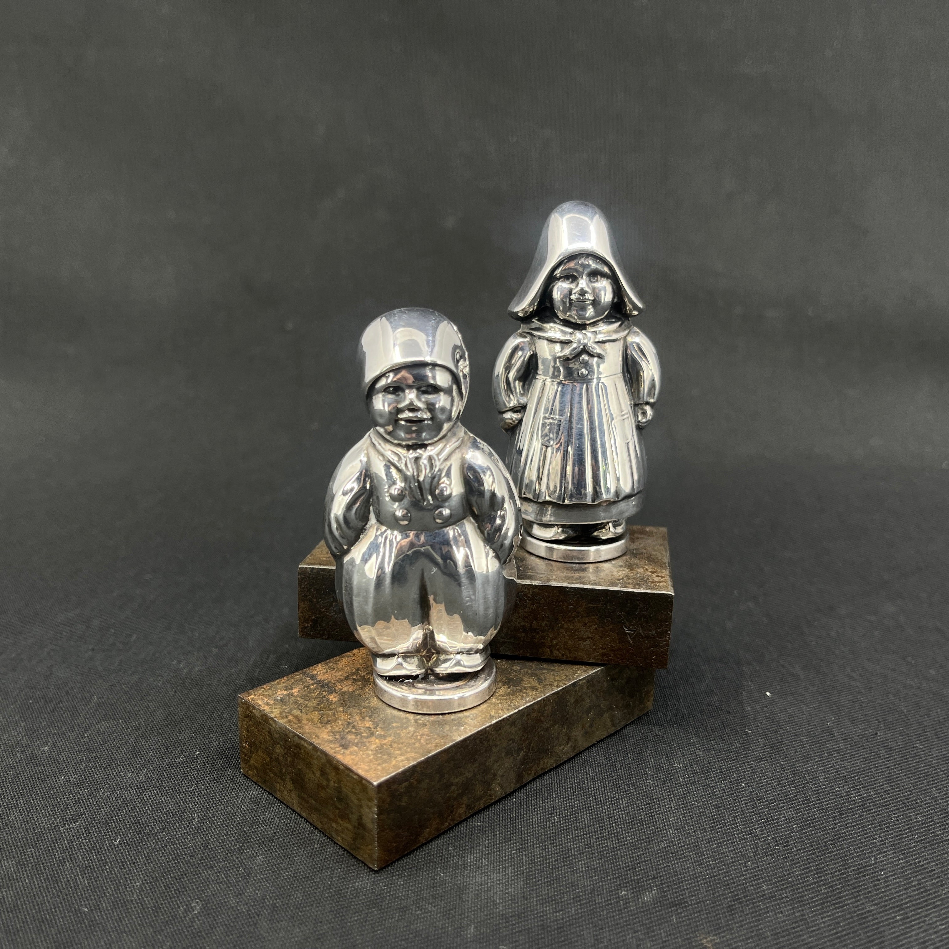 A pair of shakers in silver