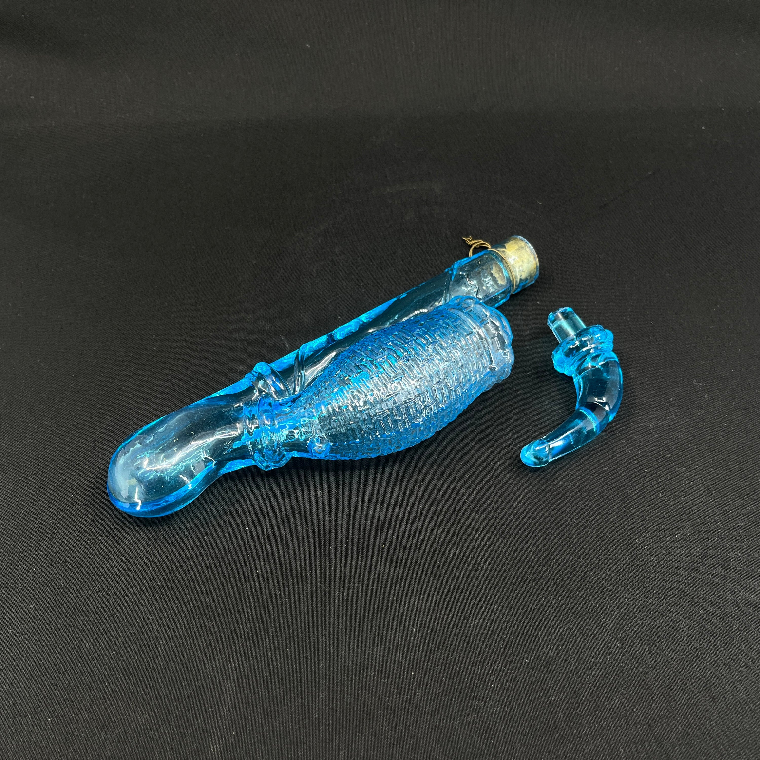 Light blue flask shaped like a long pipe