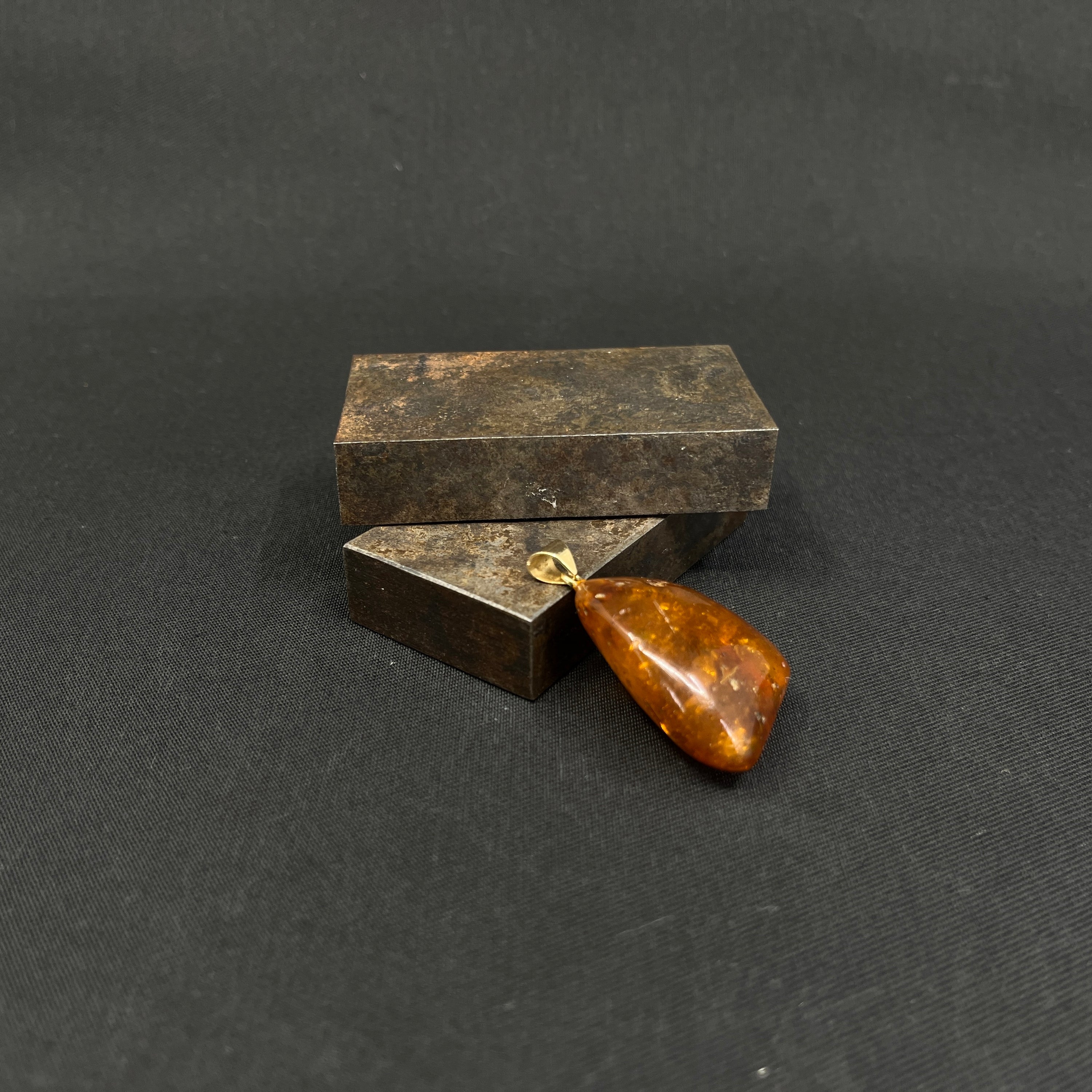 Amber pendant with gold eyelets