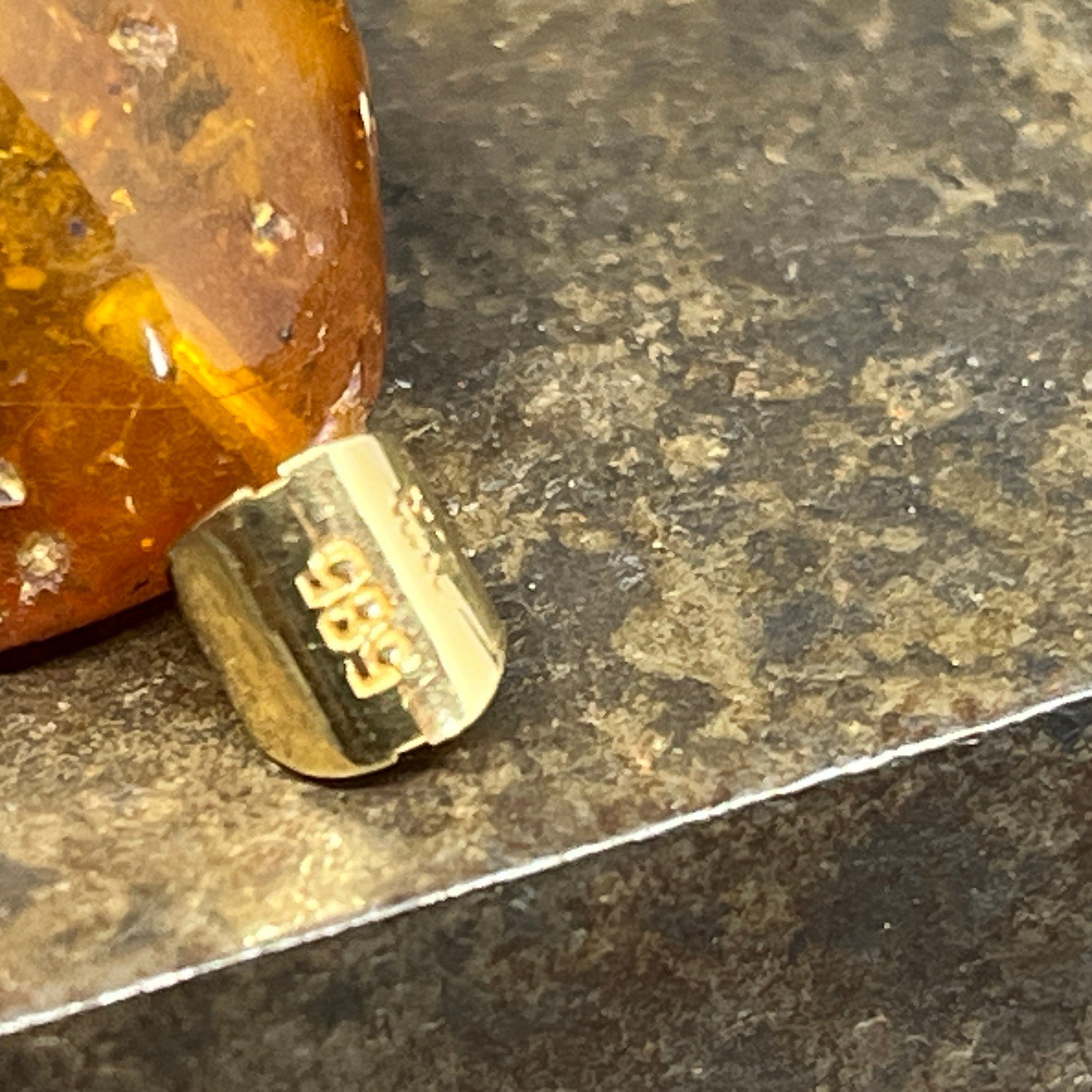 Amber pendant with gold eyelets