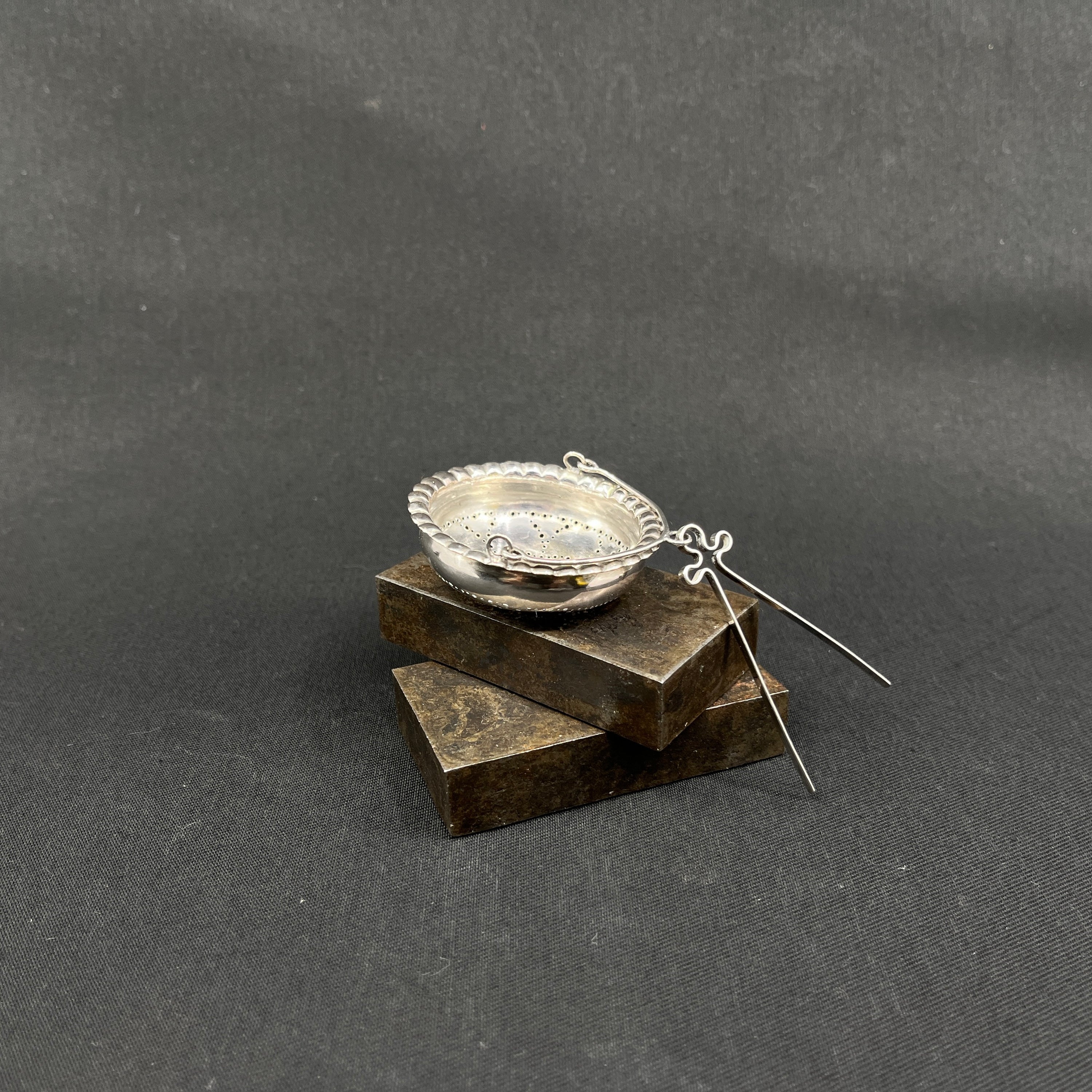 Antique round tea strainer in silver