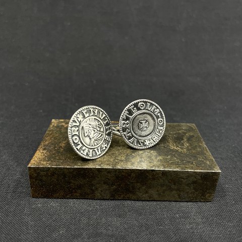 A pair of cufflinks in sterling silver