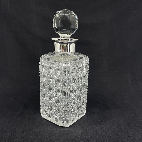 Finely cut whiskey decanter with silver collar